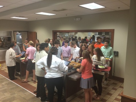 Students line up to enter their pin numbers in order to purchase their meals. The new checkout system led to slow lines at the start of the year.