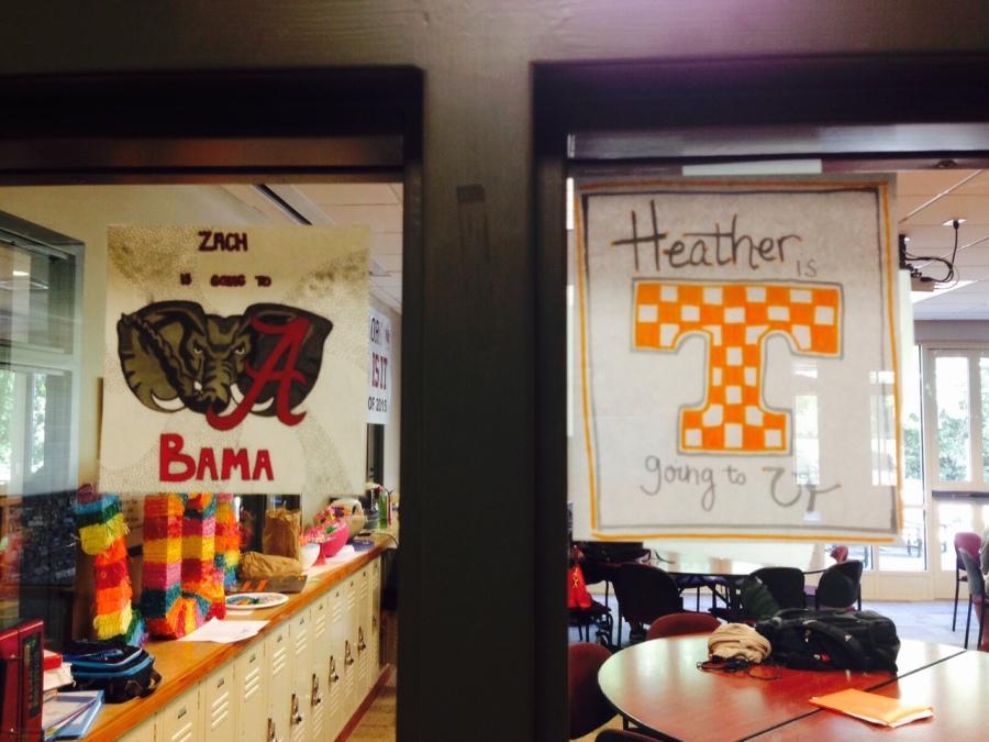 Seniors display their college signs in the windows of the senior dining hall. As the year progresses, more signs will begin to fill the windows. 