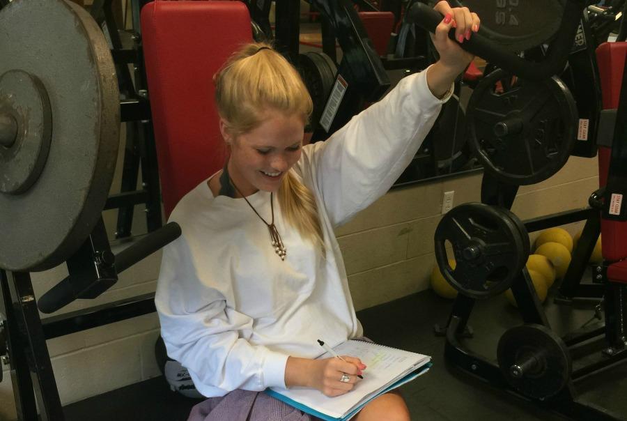 Senior Anna Weaver works out while she does her school work. Last year, she played golf and lacrosse for the school while maintaining high academic standing.