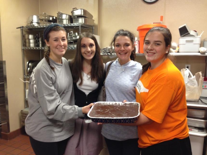 Sophomore Julie Anne Joyner and seniors Ansley Thompson, Kate Stoddard, and Heather Schaefer pose after successfully baking a chocolate cherry cake in cooking class.