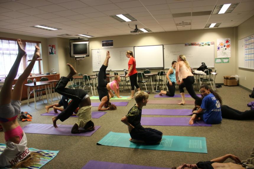 Students practice yoga poses during a half-day session. This half-day session is another session that will no longer be meeting on half-days, as well as others. 