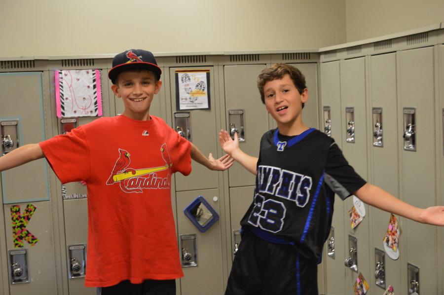 Middle school boys show off their favorite sport teams.