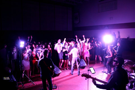 Students sing and dance along with Party Planet during the homecoming dance. Throughout the night, the band played songs varying from swing music to todays pop.