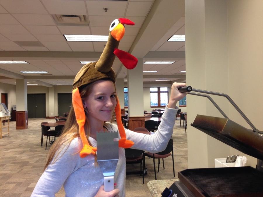 Senior Caroline Cannon admires the Panini press as she waits to begin her Thanksgiving feast. Cannon wished everyone a Happy Thanksgiving.