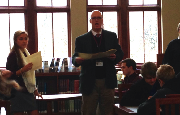 Upper-school Director, Tom Morris, hands out academic excellence awards. Students received certificates, key chains, and cookie cake for their recognition. 
