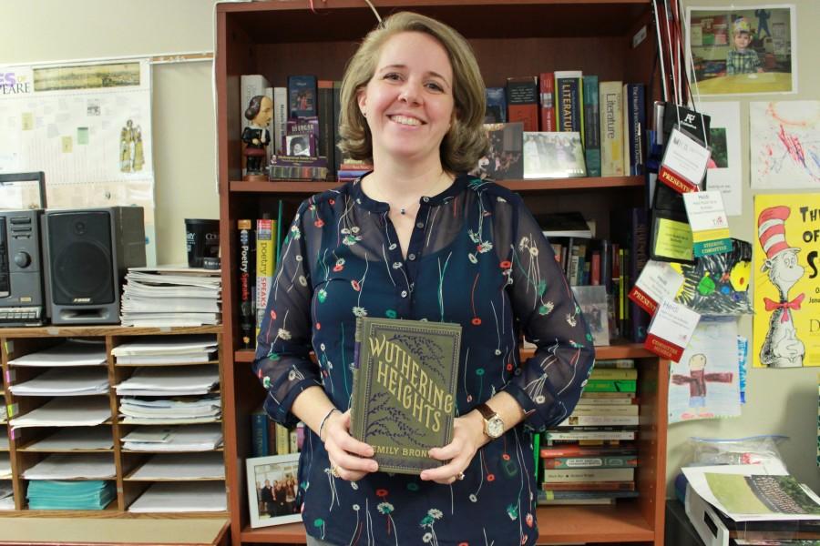 Mrs. Rubin holds up one of her favorite books. Her top five favorite books included The Once and Future King, One Hundred Years of Solitude, Wuthering Heights, The Woman Warrior, and Our Mutual Friend.