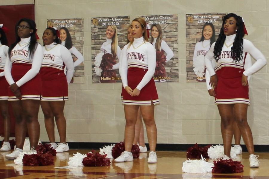 The winter cheer team cheers from the sidelines at a St. George’s basketball game. The team, led by seniors Hallie Gillam, Denise Horner, Sarah Moon and Alexa Dell, gained fifteen members this year.