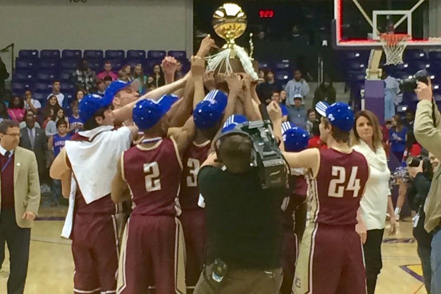 Gryphons hold the state trophy after their win. The Gryphons defeated Harding Academy by 68-45 to win the state title.
