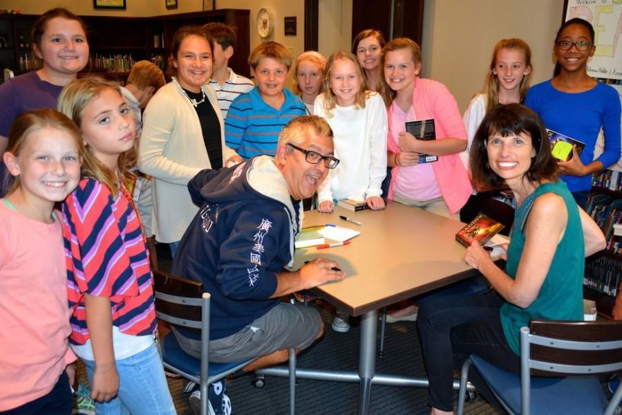 Authors+Margaret+Peterson+Haddix+and+Kevin+Sylvester+pose+with+fifth-grade+students+during+their+book+signing.+The+book+signing+took+place+before+the+authors+presentations%2C+which+were+opportunities+for+the+authors+to+advertise+their+upcoming+books.