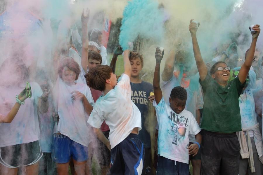 The eighth grade class throws their last batch of colored starch at the middle school color run. Students got to throw yellow, pink, green, and purple colored starches at their friends. 