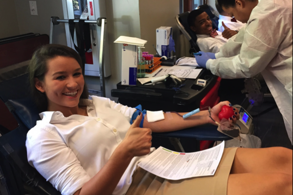 Sophomore Kate Seabrook and junior Alton Stovall donate blood in the senior lounge. Both students and teachers donated blood during the fall blood drive on Friday, Oct. 16.