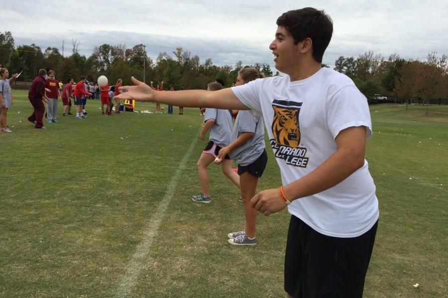 Sophomore David Quesada tosses an egg to his partner. One of the field days events was an egg toss.