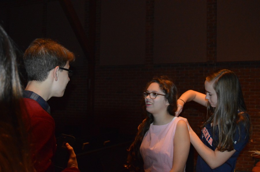 Sound team member and sophomore Merryn Ruthling helps Emma Pounders with her mic. Bye Bye Birdie premieres on Friday, Nov. 6 and runs to Sunday, Nov. 8.