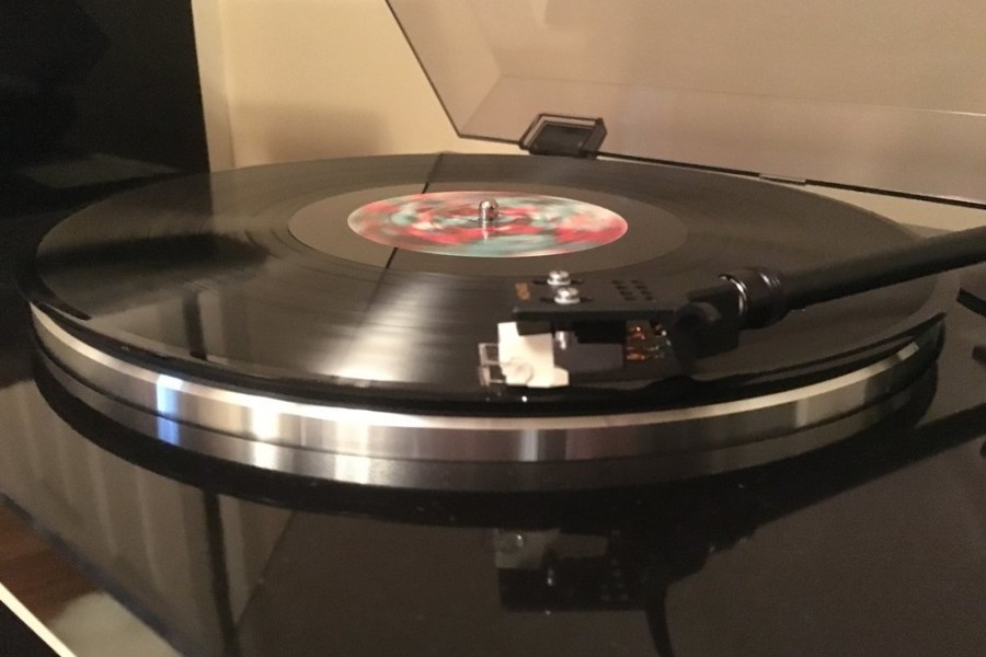 A record player plays new music from Coldplay. Coldplay, G-Eazy and Kid Cudi all released new albums within the month of December.
