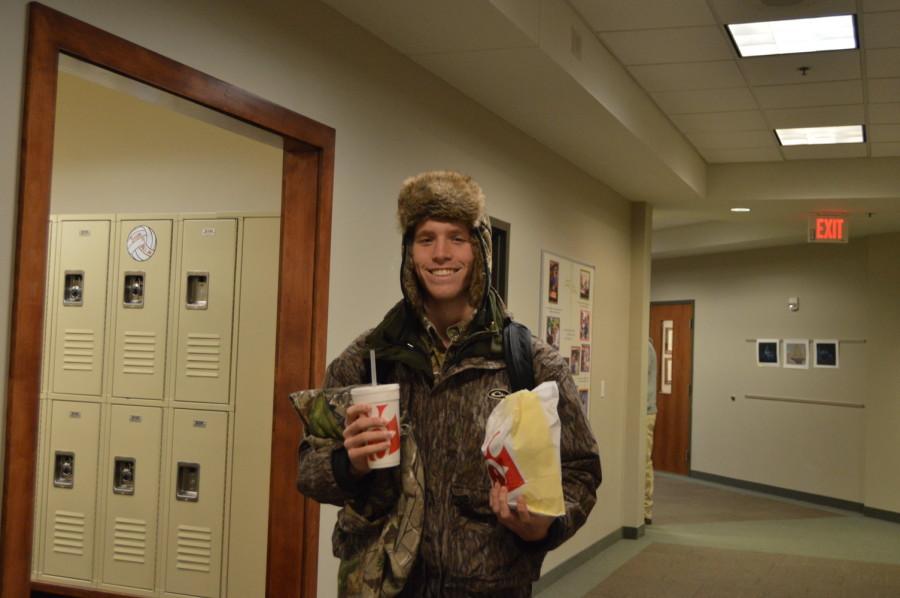 Senior+William+McBride+holds+his+Chick-fil-A+while+wearing+camouflage.+Wednesdays+spirit+week+was+hide+and+seek+day%2C+and+freshmen+and+juniors+wore+neon+while+sophomores+and+seniors+wore+camouflage.