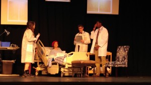 Sophomore Margo Valadie and seniors Ellie Babb, Noah Woods and Teddrick Boyd perform a scene during one of their final dress rehearsals. The four individuals played a hospital technician, Dr. Vivian Bearing, Dr. Jason Posner and Dr. Harvey Kelekian, respectively. 