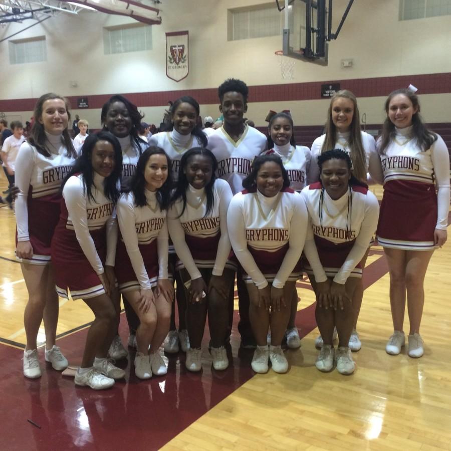 The winter cheer squad poses at a basketball game. JR joined the team this year, making school history as the first male cheerleader.