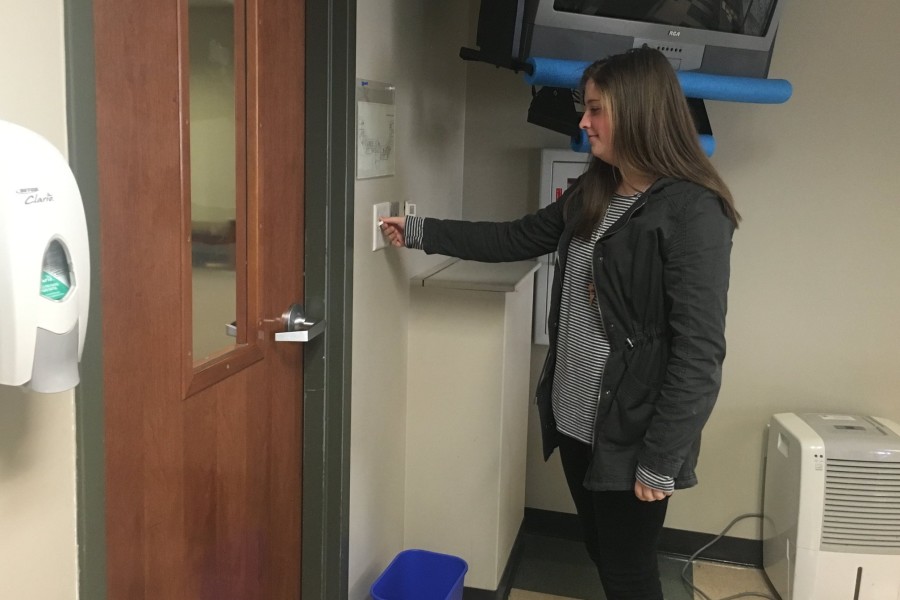 Sophomore Caroline Zummach turns off the light switch to conserve energy. In the first week of the competition, St. George’s reduced their carbon emission by 26,000 pounds.