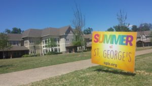 A sign for the Summer at St. George’s program stands on the lawn of the Collierville Campus. the sign was advertising the new summer programs.