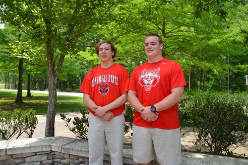 Seniors Alston Foster and Jacob Still pose for a photo in their Arkansas State shirts. The class of 2016 showed their college spirit by wearing college t-shirts on May 11.