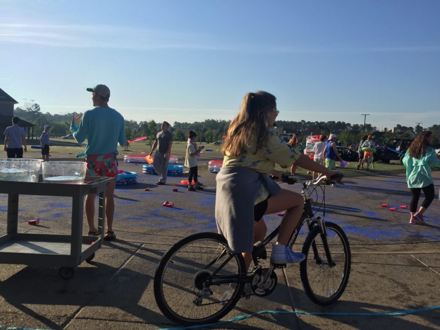 Senior Caroline Green rides her bicycle around the front of the school during the prank. The class of 2016s senior prank was held on Thursday, May 19, in the theme of the 30A beaches.