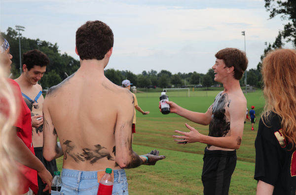 Students paint their bodies for the first home game. The color theme for the game was black.