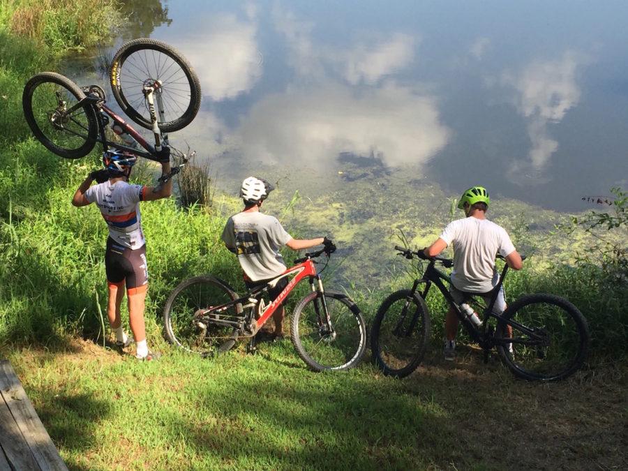 Team founders and seniors Kneeland Gammill and J.D. Hibner gaze over Bulldog Lake after a ride with junior Soren Jensen. The new mountain bike team began rides at the end of August.