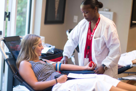 Sophomore Caroline McDowell gives blood. McDowell was one of the many St. George's students to give blood on Sept. 12.