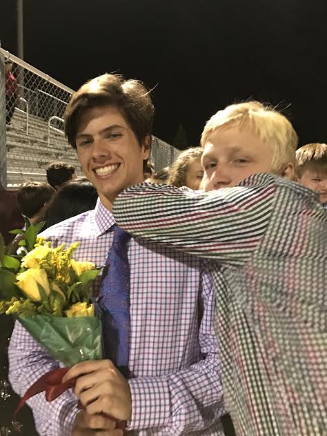 Juniors Bart Mueller and Graham Smith pose for a photo following the presentation of the Homecoming Court.  The Homecoming game took place on Sept. 30. 