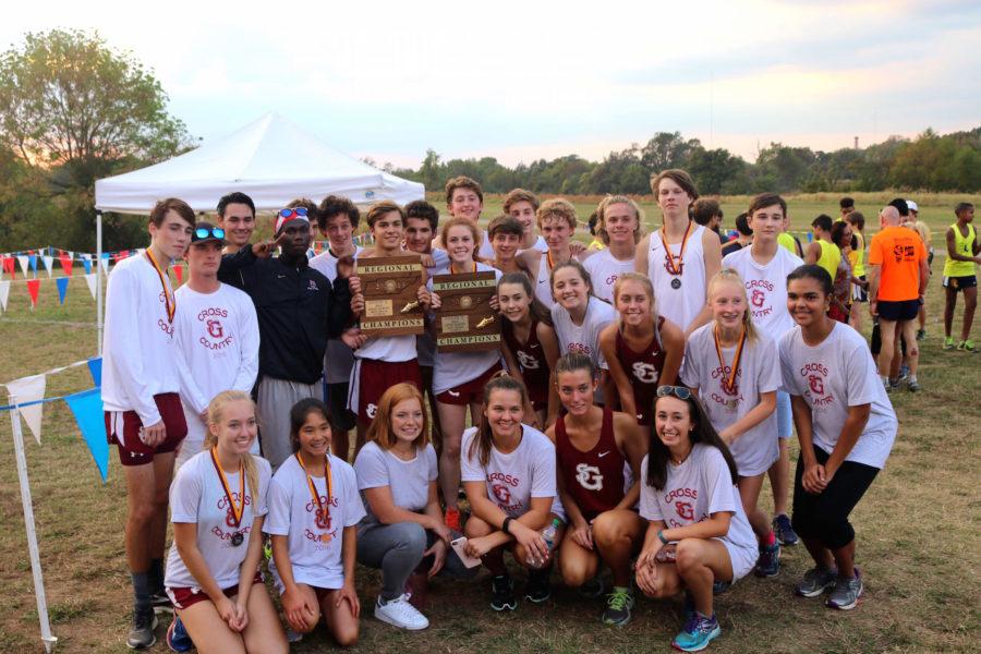 The varsity cross country teams pose with their regional trophies. Four runners from each team finished in the top 10. 