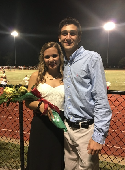 Seniors Elizabeth Evans and Morgan Wirth pose together following the presentation of the Homecoming Court. Evans was a member of the court. 