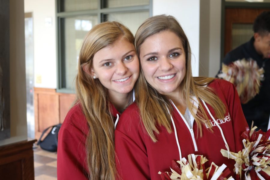 Senior cheerleaders Elizabeth Evans and Hayes Franklin wait to send off the soccer team. The varsity soccer team won Friday, Oct. 21, which secured their spot in the state semifinals.