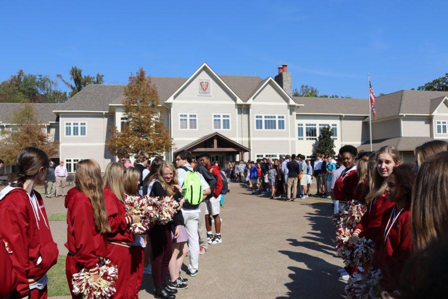 High school students line up to send off the soccer team. The varsity soccer team won Friday, Oct. 21, which secured their spot in the state semifinals.