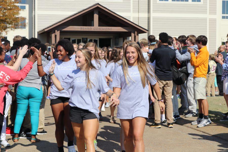 Seniors Eva Neel and Avery Whitehead lead the soccer team to the bus. The varsity soccer team won Friday, Oct. 21, which secured their spot in the state semifinals.