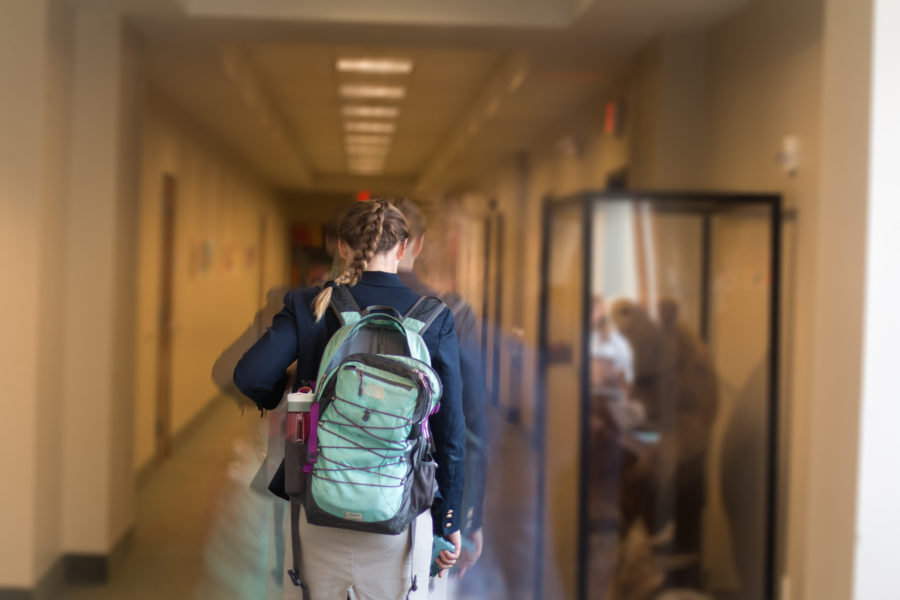 A student walks to their next class. Students have felt more calm since implementing the new schedule. 
