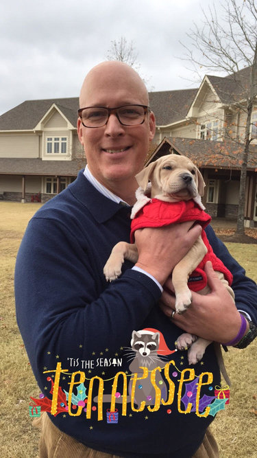 Upper School Director Mr. Morris poses for a photo with one of the Paws for Exams puppies. Puppies were brought to school as a part of Mary Maddux Whites Senior Independent Study. 