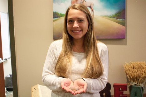 Senior Avery Whitehead poses with coins in spirit of the Coins for Carson drive. Whitehead coordinated the Coins for Carson drive. 