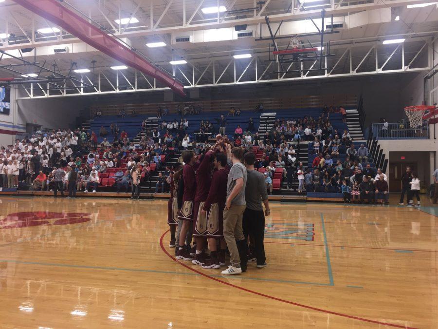 Members of the varsity boys team huddle up before the game begins. Both the boys and the girls teams sadly lost their games. 