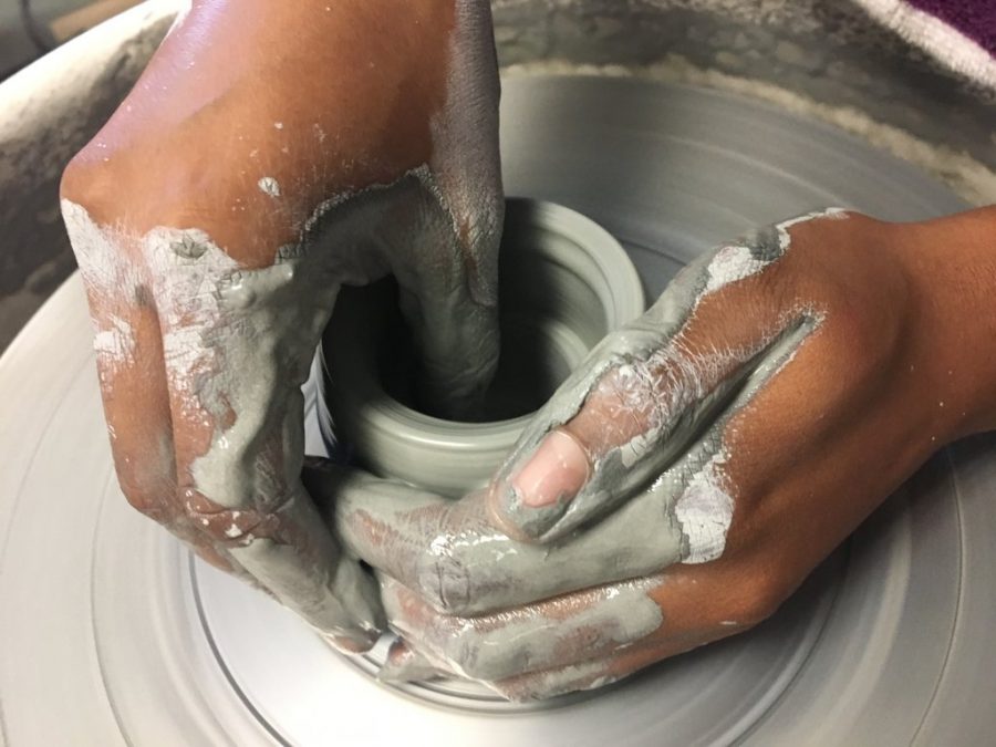 Senior Sydney Brown throws on the wheel in pottery class. Brown started pottery as a semester class this January. 