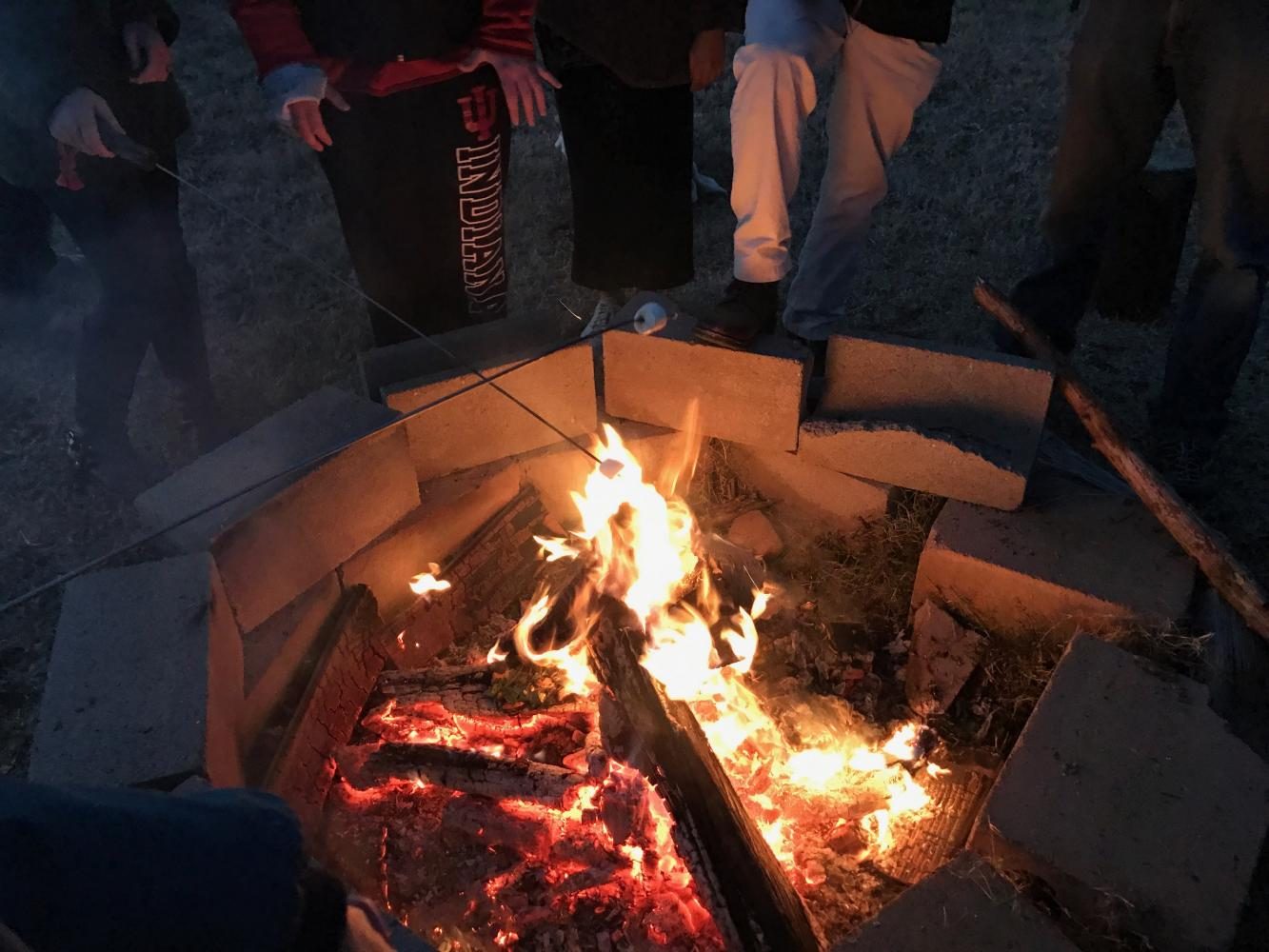 At the Fall Fest, students roast marshmallows. Students came face-to-face with the real-world challenges of running a small scale farm.