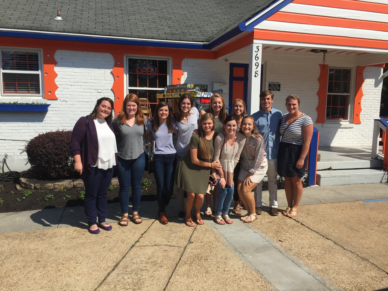 Students stand in front of Arepas Deliciosas. Spanish students traveled to Arepas Deliciosas for lunch after taking the practice AP Spanish exam.