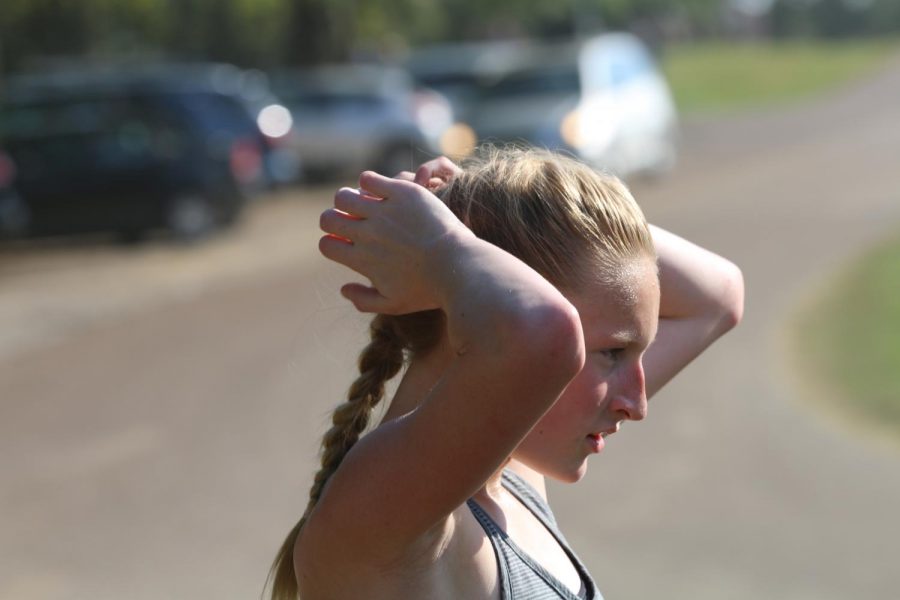 Freshman Allison Newman catches her breath after running a series of sprints at practice. Newman broke the St. Georges 5K record within the first three weeks of the cross country season. 
