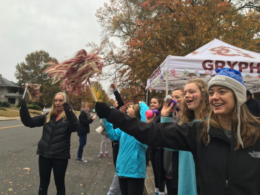 Upper school math teacher Mrs. Kimberly Callaway, sophomore Boo McWaters and St. Georges alumni Maggie Glosson and Grace Bennett cheer on runners during last years race. More than 25,000 people are projected to participate in the Memphis Marathon Weekend this year. 