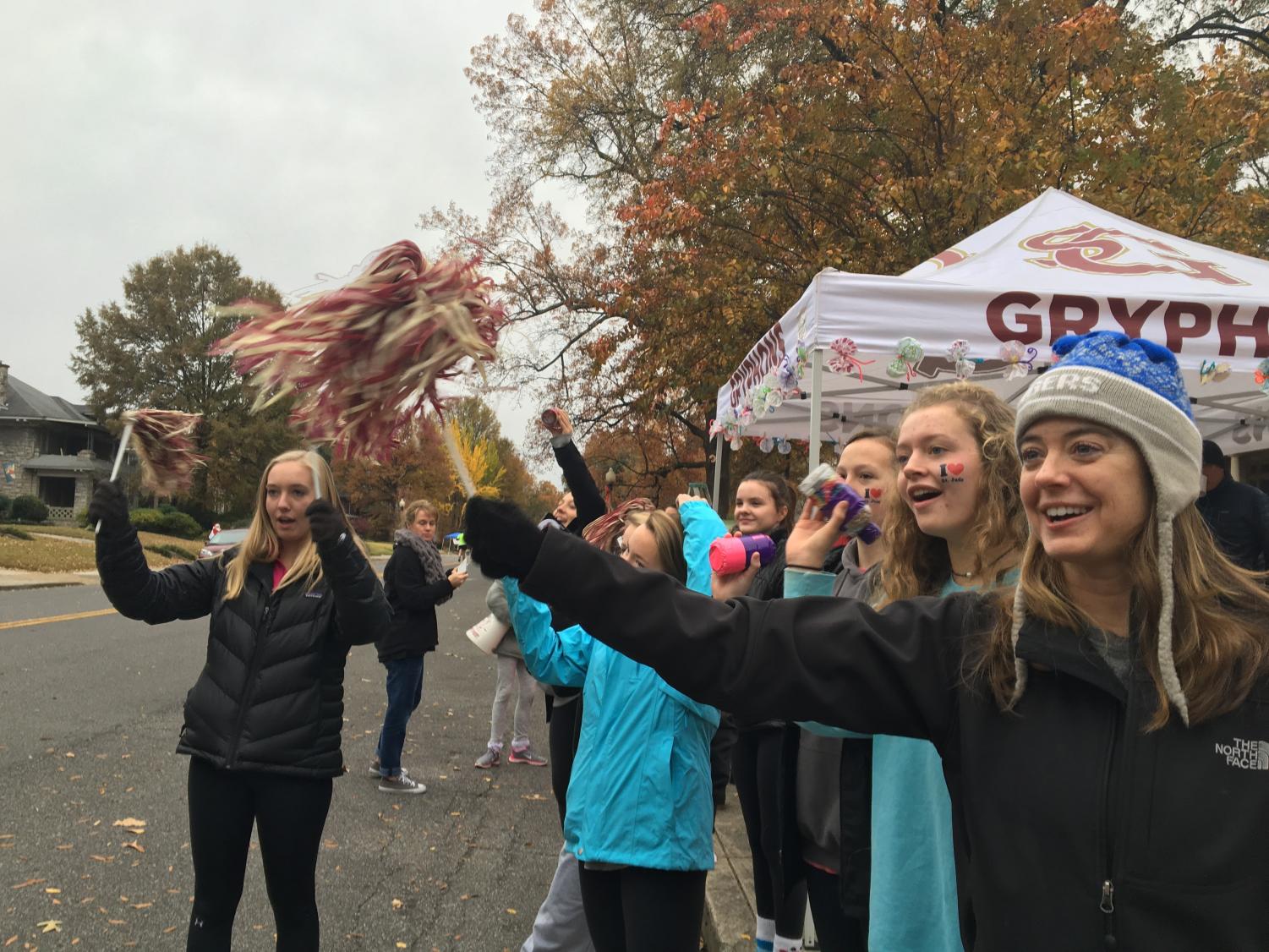 Upper school math teacher Mrs. Kimberly Callaway, sophomore Boo McWaters and St. George's alumni Maggie Glosson and Grace Bennett cheer on runners during last year's race. More than 25,000 people are projected to participate in the Memphis Marathon Weekend this year.