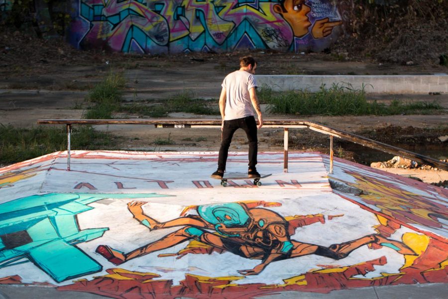 A skateboarder glides over the finished murals at Altown Skatepark. In the wake of Paint Memphis, the area was brought to life with new artwork.