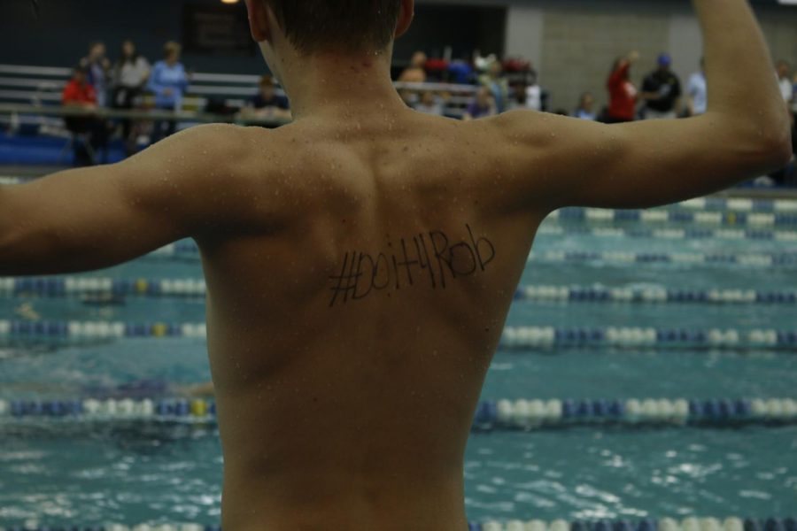 Multiple Gryphon swimmers have #Doit4Rob written on their backs or on their arms. Junior Maggie Murphy said the team does it because “we want to make our coach proud.”
