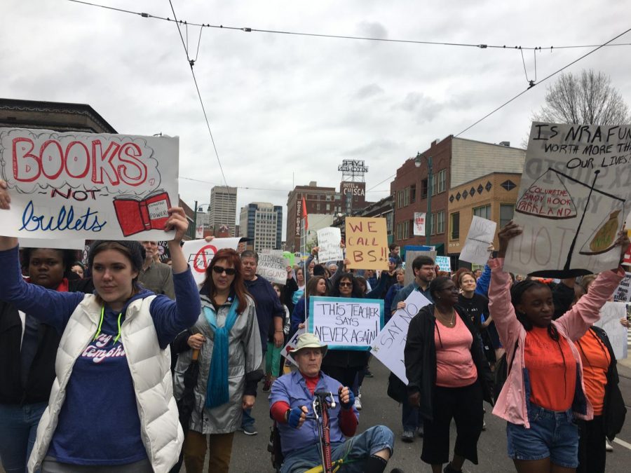 People+hold+up+signs+in+support+of+reformed+gun+control+laws+at+the+March+for+Our+Lives.+The+march+was+a+nationwide+movement+and+Memphis+was+one+of+the+cities+that+participated+in+the+march.