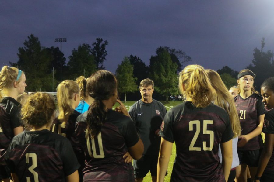 The Lady Gryphons gather together during a game. Recently, the soccer team has started to form traditions that have brought them closer together.