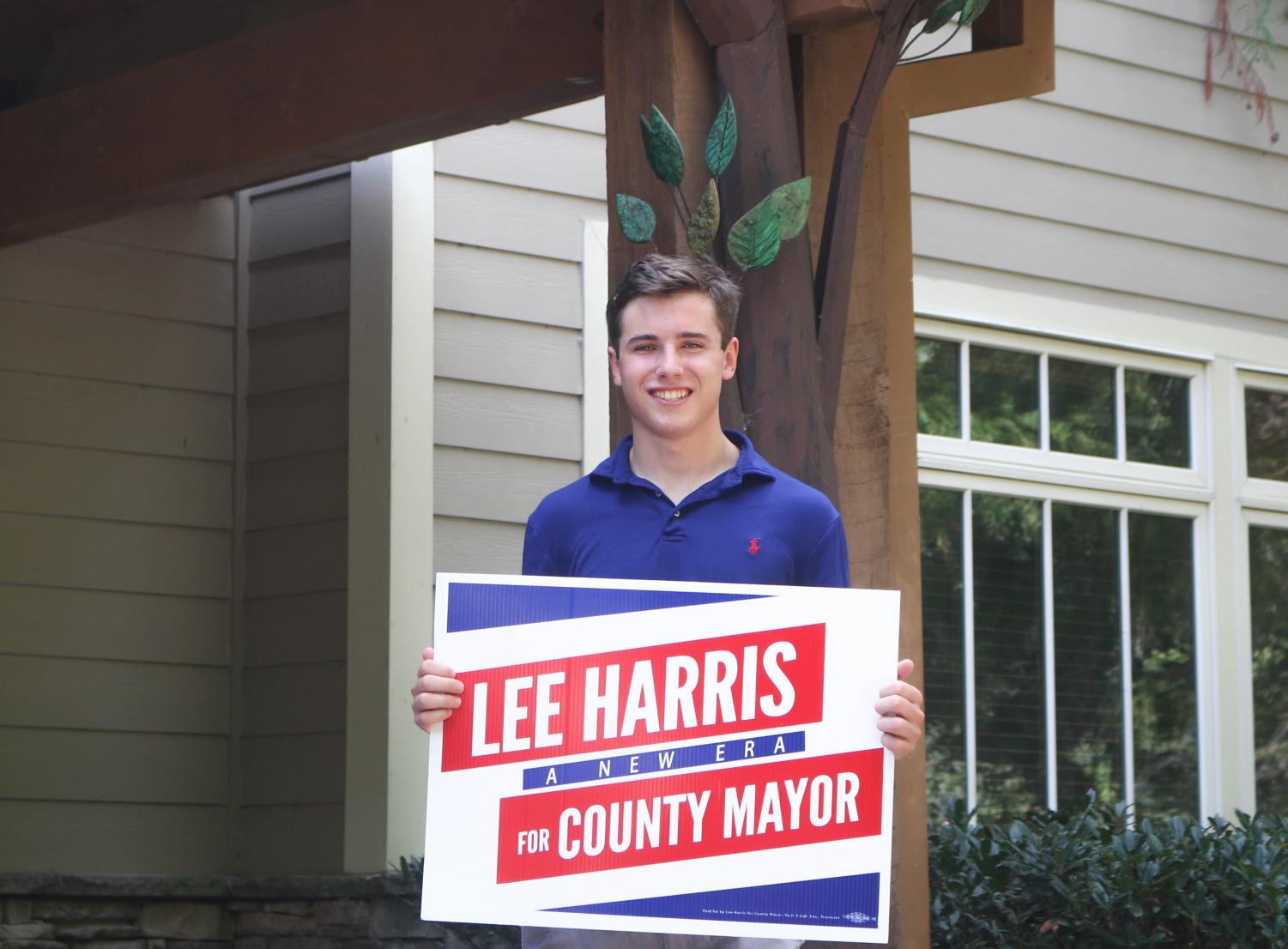 St. George’s alumnus poses with a Lee Harris sign from the recent campaign. Doucette said the experience of working on the campaign helped him learn leadership skills.