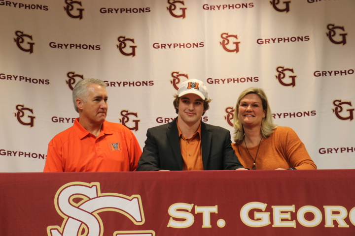 Senior Justin Bray poses with his parents. Bray committed to Mercer University on February 6, 2019.